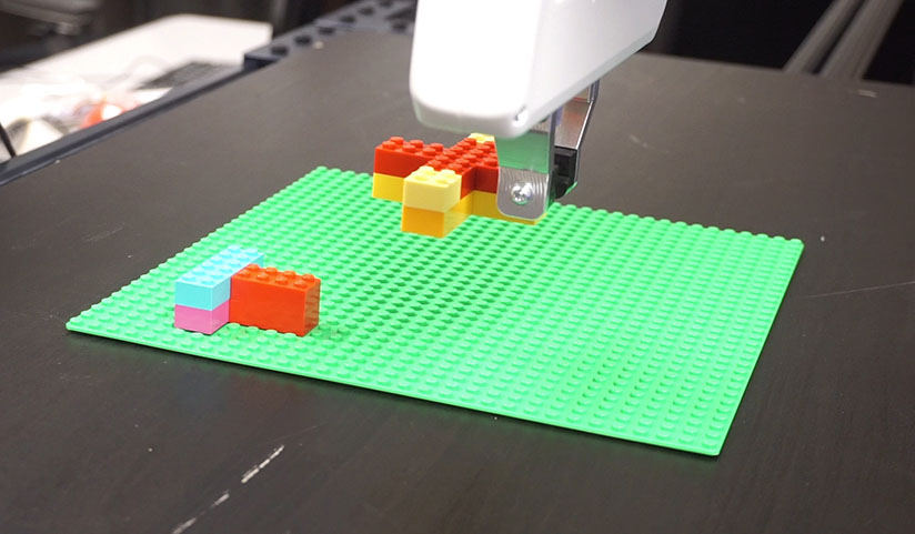 robot placing Lego bricks
