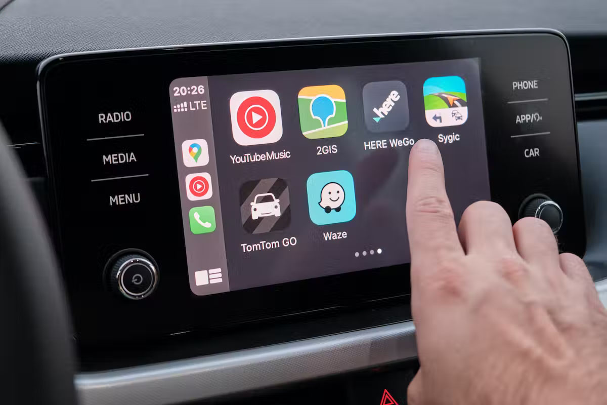 Finger pressing car infotainment system screen