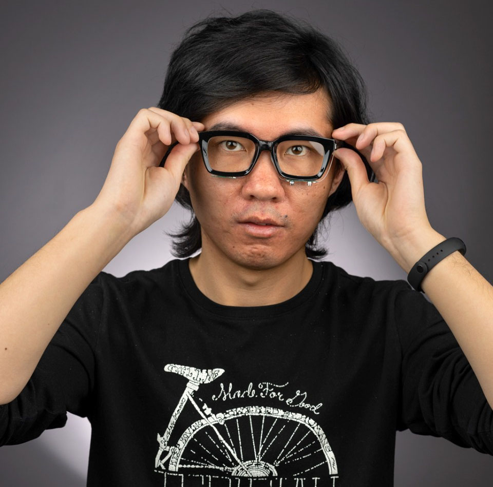 Ruidong Zhang, a doctoral student in the field of information science, wearing EchoSpeech glasses