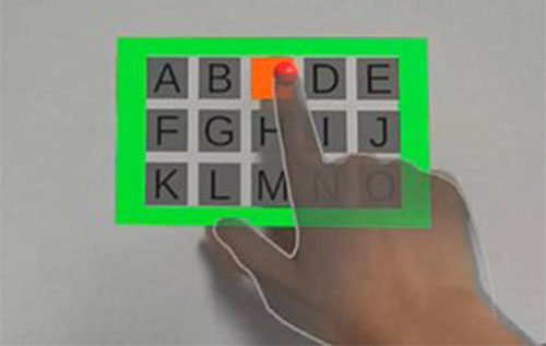 Example use of the technique: a wall is used as a touch input surface to interact with a virtual interface