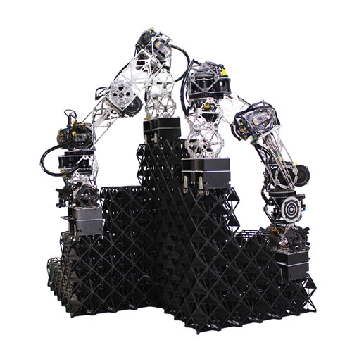 Two robots work together to build a voxel structure.