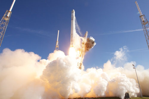 Falcon 9 rocket carrying the Dragon spacecraft as it lifts off