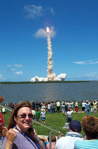 Deborah Kimbrell gives the thumbs up signal as space shuttle Discovery launches her study subjects to space