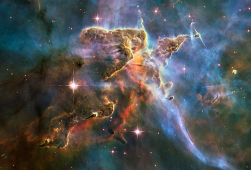 stars forming inside a cloud of cold hydrogen gas and dust in the Carina Nebula