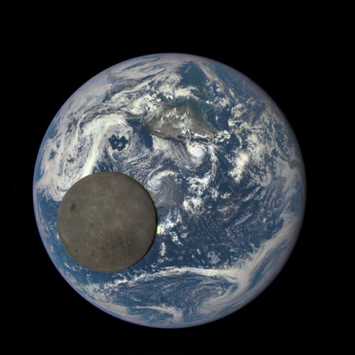 This image shows the far side of the moon crossing the Earth