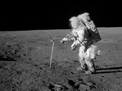 Astronaut Alan L. Bean, lunar module pilot, drives a core sample tube into the lunar surface during the Apollo 12 extravehicular activity