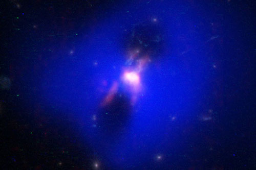This composite image shows powerful radio jets from the supermassive black hole at the center of a galaxy in the Phoenix Cluster