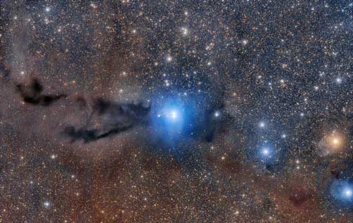 Lupus 3 - A dark cloud of cosmic dust snakes across this spectacular wide field image, illuminated by the brilliant light of new stars