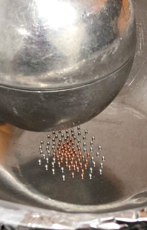 spheres in a shallow stainless-steel kitchen mixing bowl