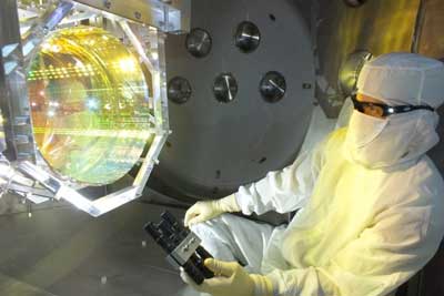 a LIGO optics technician inspects one of LIGO’s mirrors