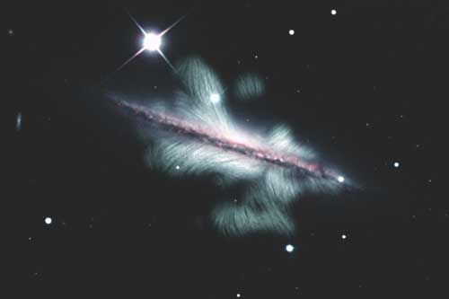The spiral galaxy NGC 4217 has a huge magnetic field that is shown here as green lines