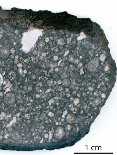 An example of a meteorite studded with chips of rock from earlier ages