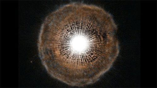 A red giant star, Camelopardalis, emits a shell of gas as a layer of helium around its core begins to fuse