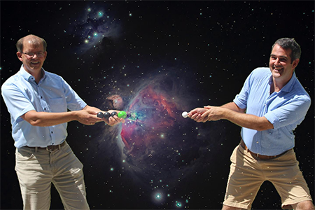 Physicists Roland Wester (left) and Malcolm Simpson (right) demonstrate how dipole-bound states allow negative ions to form in interstellar clouds