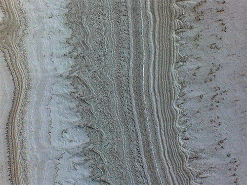 This image taken by NASA’s Mars Reconnaissance Orbiter shows ice sheets at Mars’ south pole