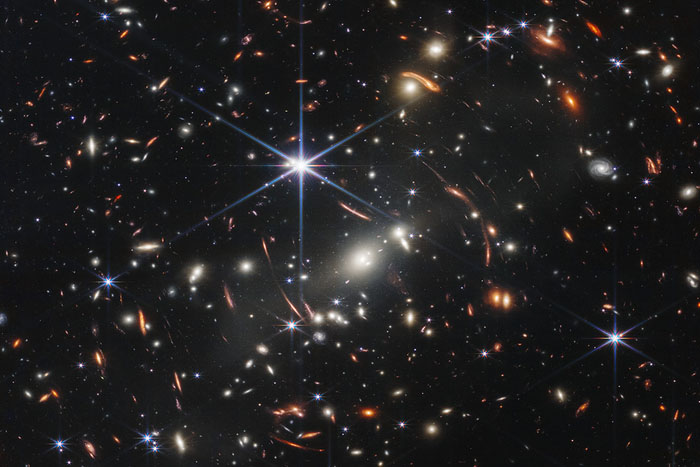 Thousands of galaxies flood this near-infrared, high-resolution image of galaxy cluster SMACS 0723