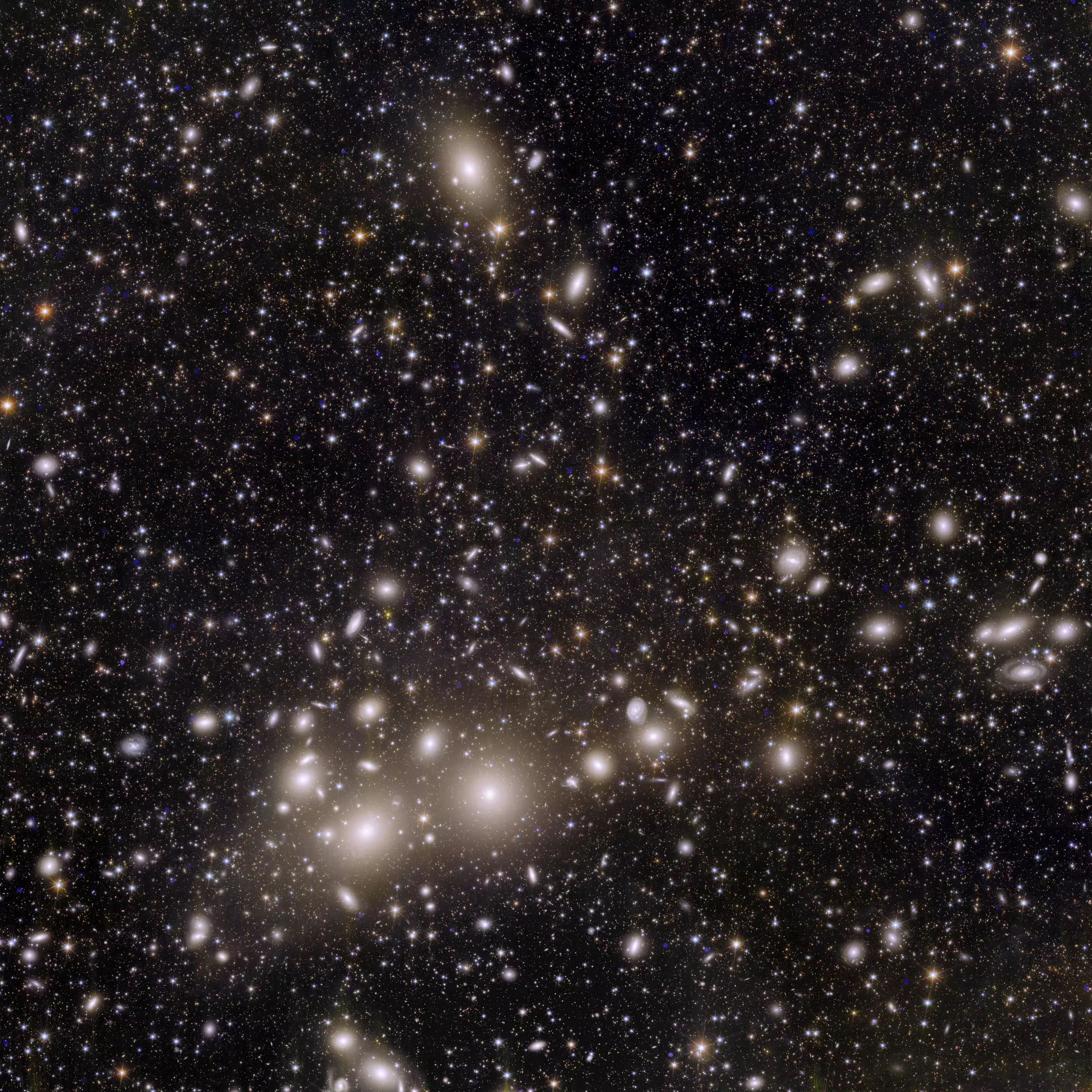 Square image with black background and a collection of scattered point-shaped white light sources next to many small and larger blurred spots
