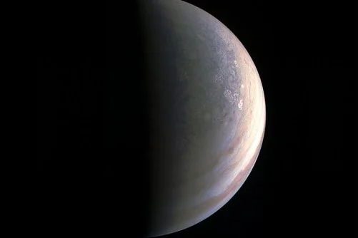 This image from NASA's Juno spacecraft in 2016 shows the north polar region of Jupiter. The JunoCam obtained this view about two hours before closest approach, when the spacecraft was 120,000 miles from Jupiter.