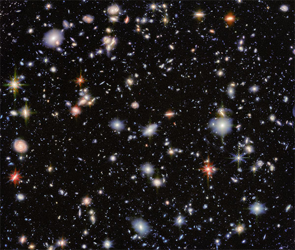 This image combines data from the JWST's MIRI and NIRcam cameras to create a multicolour view of the Hubble Ultra Deep Field.
