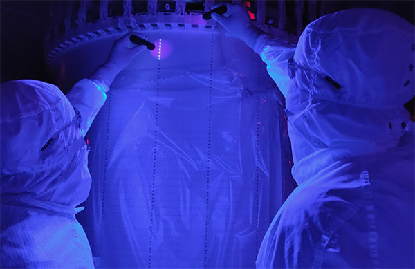 Researchers use UV light to scan for possible dust contamination at the detector's time-projection chamber