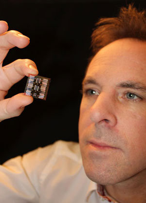 Dr Neil Kemp holds an optically tuneable memristor device